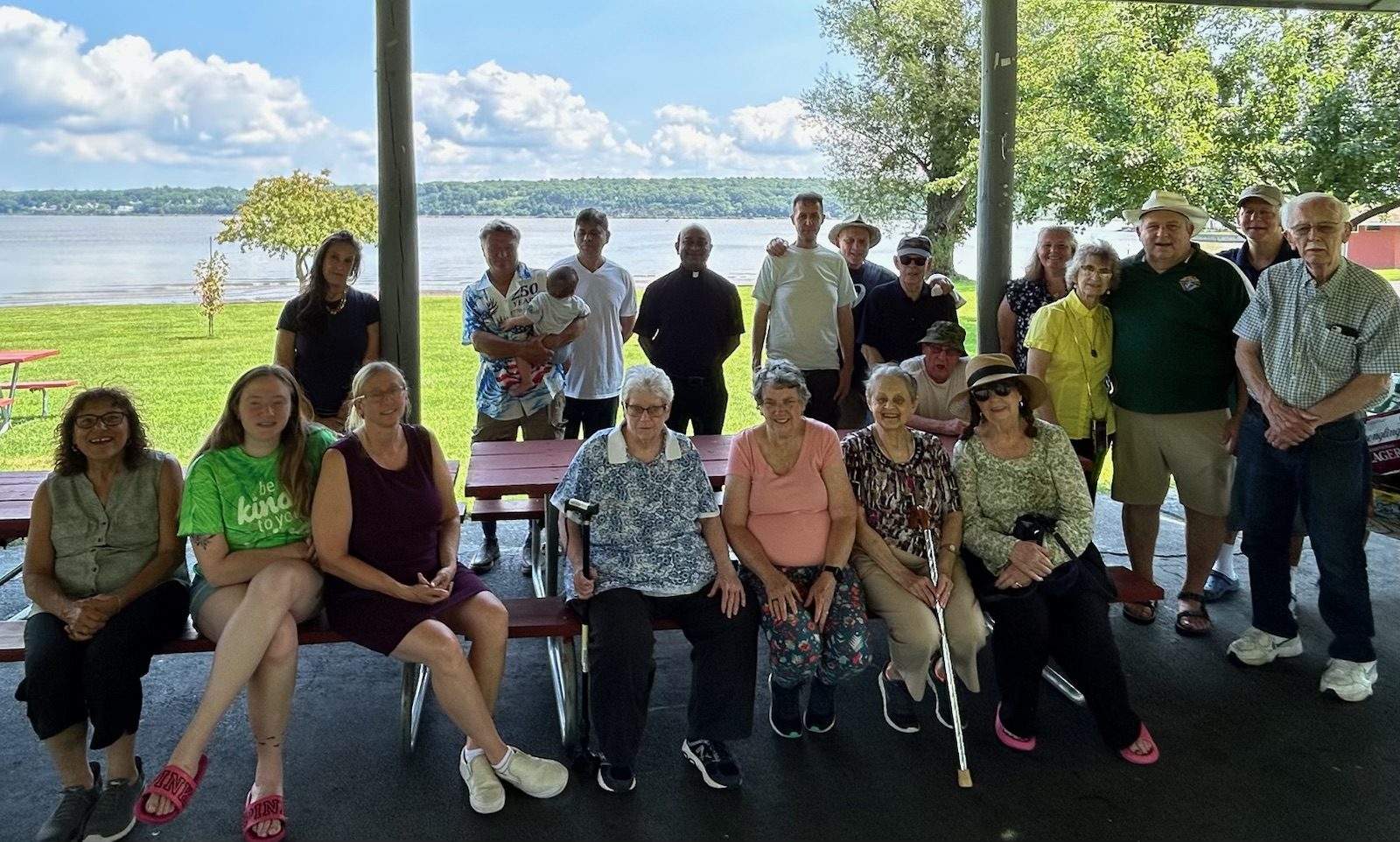 Members, families and friends of the Council gathered under a pavilion beside the Hudson River